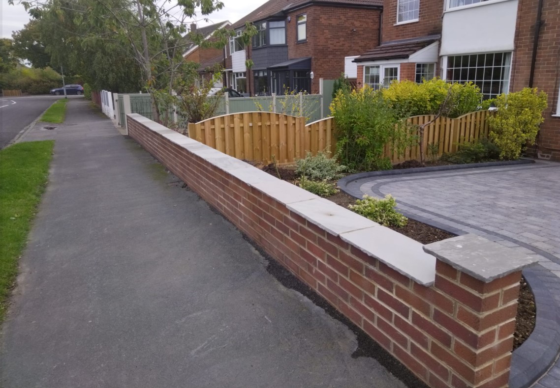Finished grey paved driveway, new timber fence and brick boundary wall