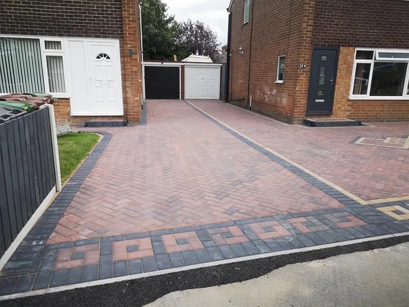 Completed block-paved frontage with a geometric charcoal border